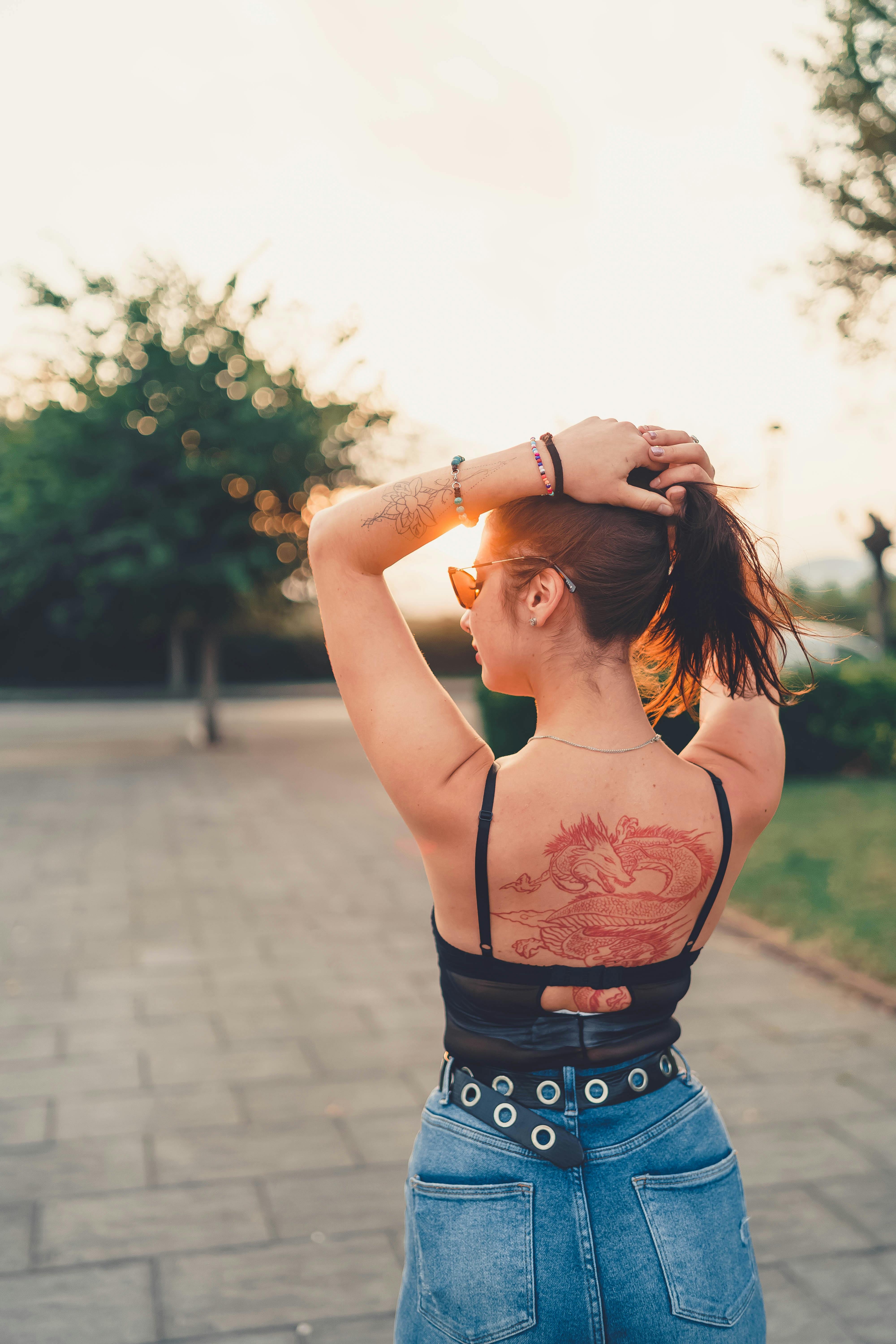 Backside of a Woman with Full Back Tattoos · Free Stock Photo