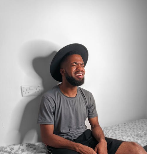 Free stock photo of black man on hat, eyes closed Stock Photo
