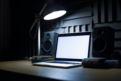 Free Close-Up Shot of a Laptop beside a Lamp Stock Photo