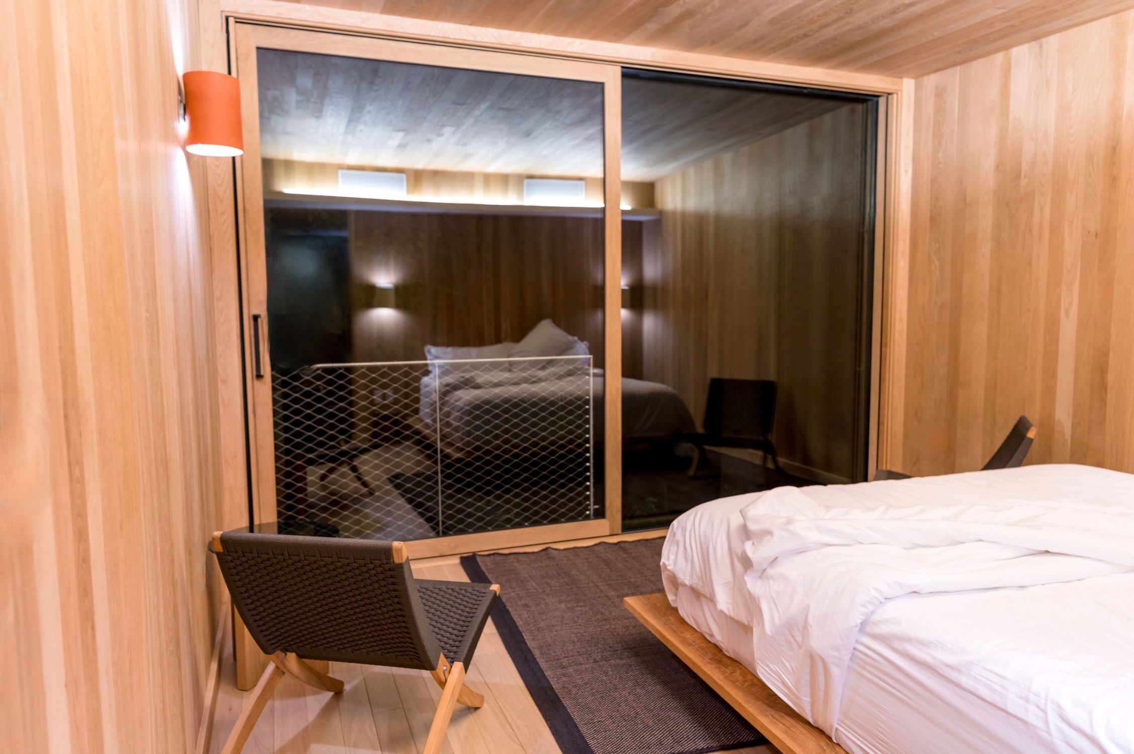 A stylish modern bedroom with wooden decor and sleek furniture for a serene ambiance.