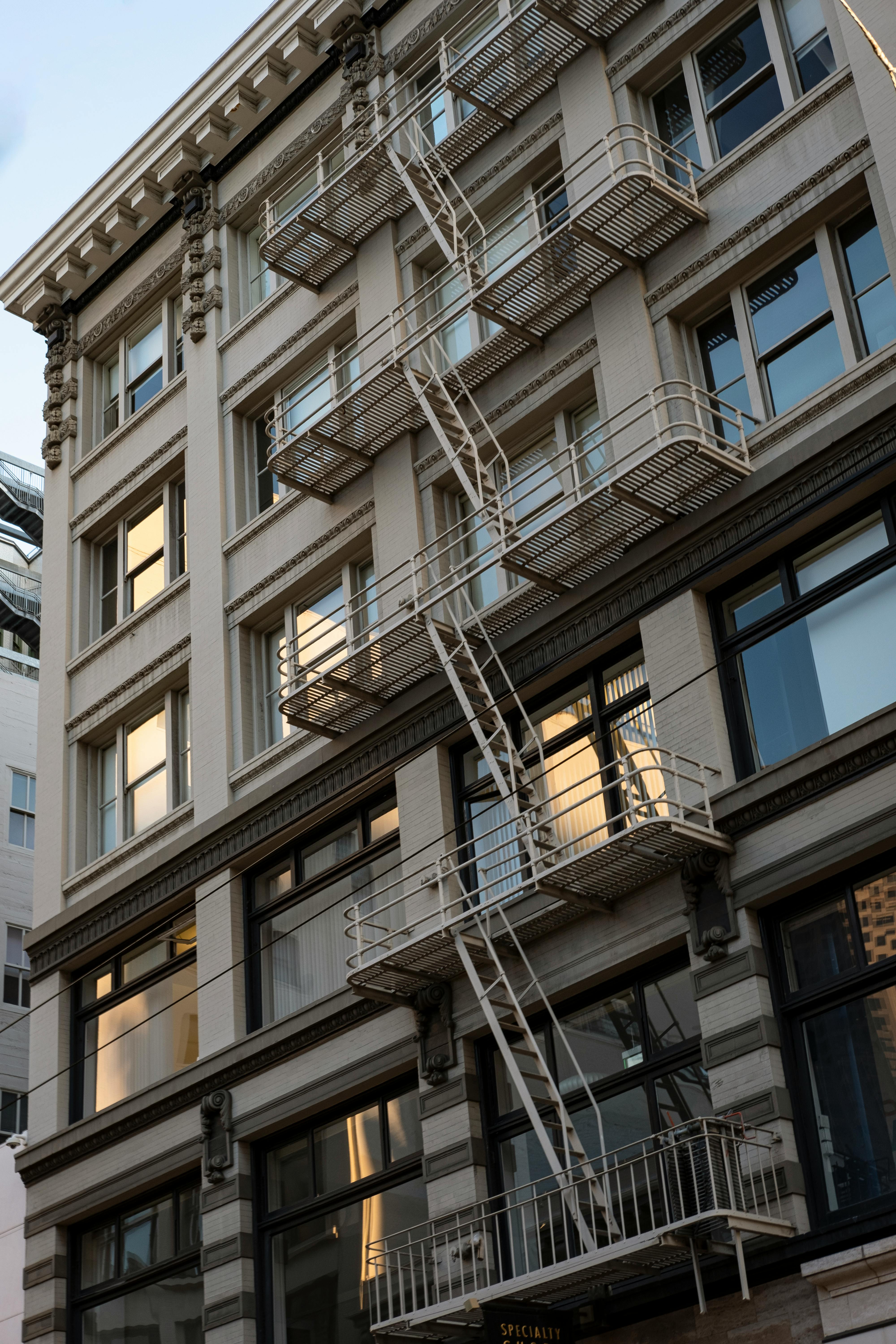 Apartment Building with Fire Escape Ladders · Free Stock Photo