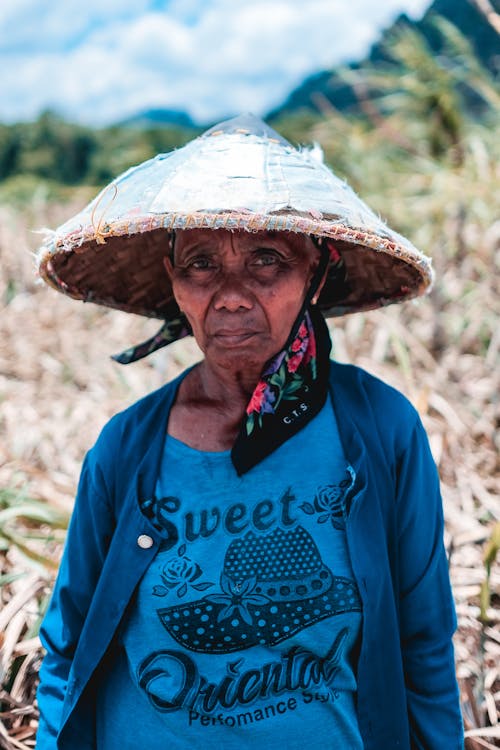 An Elderly Woman Wearing a Bamboo Hat