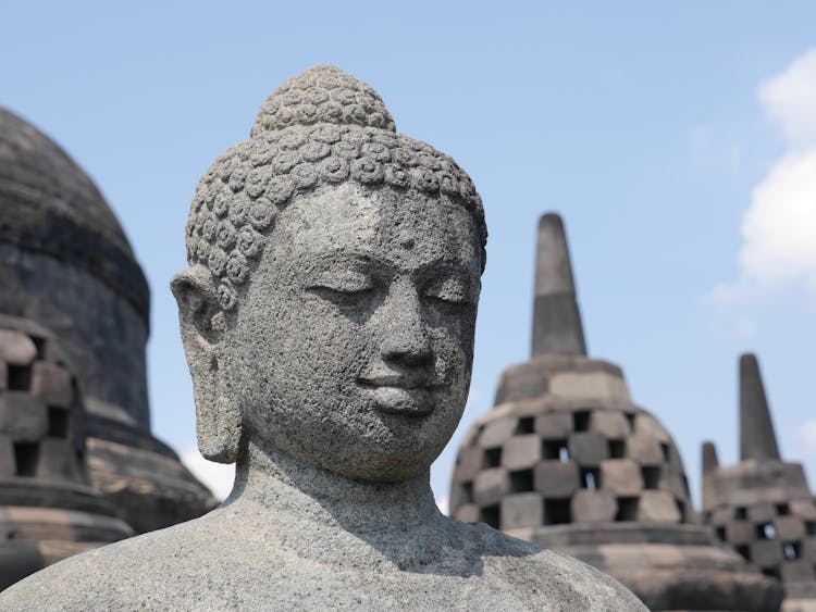 Stone Buddha Statue Against Blue Sky