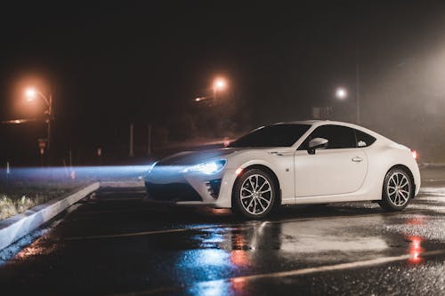 A Parked Toyota Subaru with Open Headlights