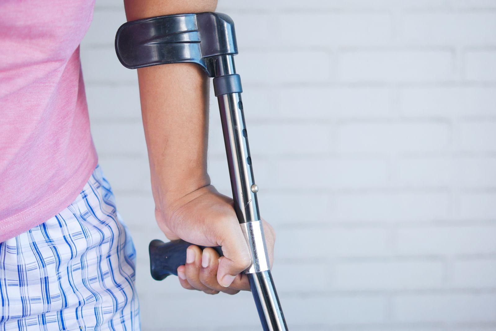 Runner adjusting a knee brace outdoors before activity