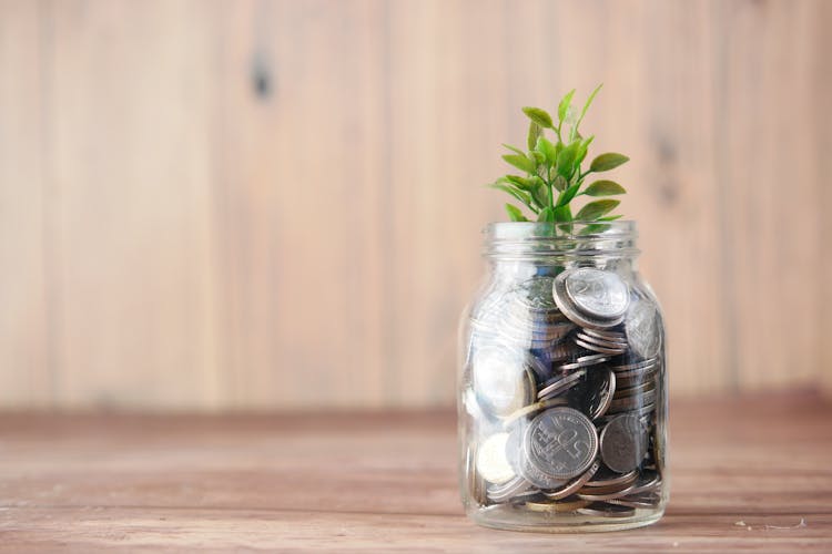 Close-Up Shot Of A Jar With Coins