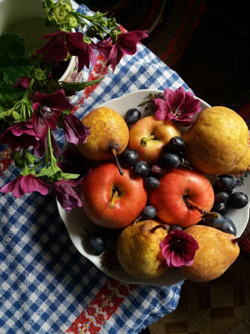 Close-Up Shot of Grapes and Apples in a Bowl