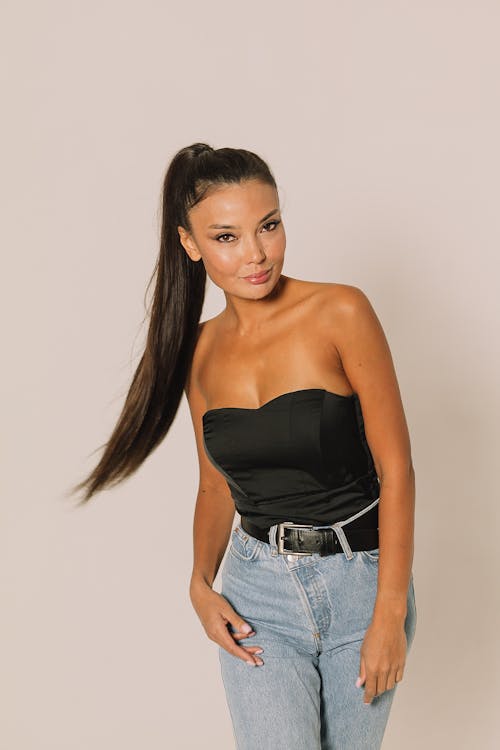 A Woman in Black Top and Denim Pants