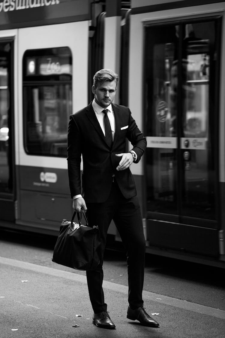 Full-suited Man Standing On Rail Station