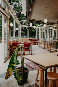 Modern restaurant with open seating, natural light, and stylish decor.