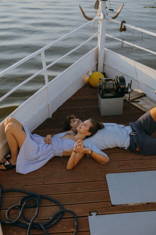 Free A Romantic Couple Lying on a Yacht Stock Photo