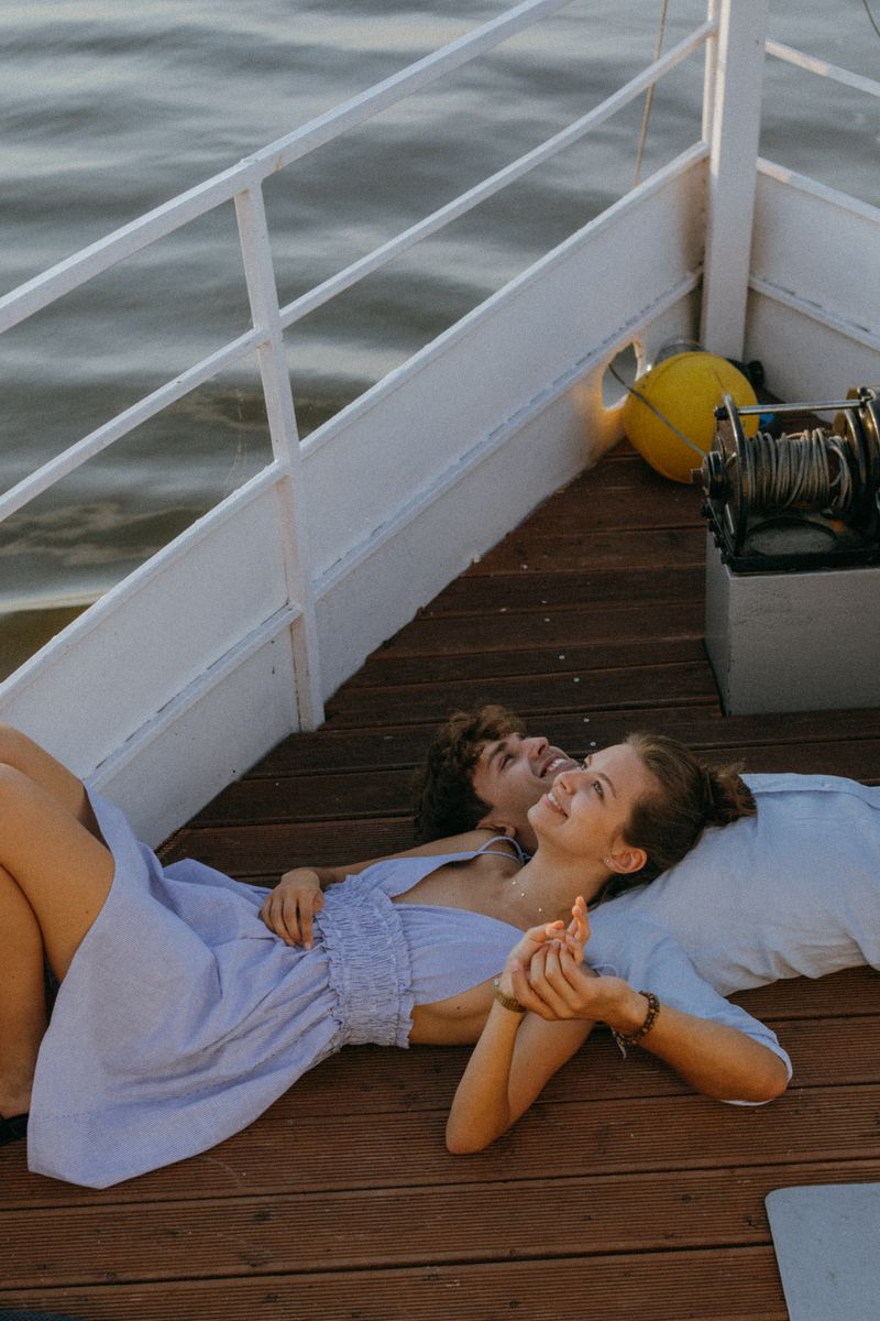 Couple relaxing on a yacht deck at sunset