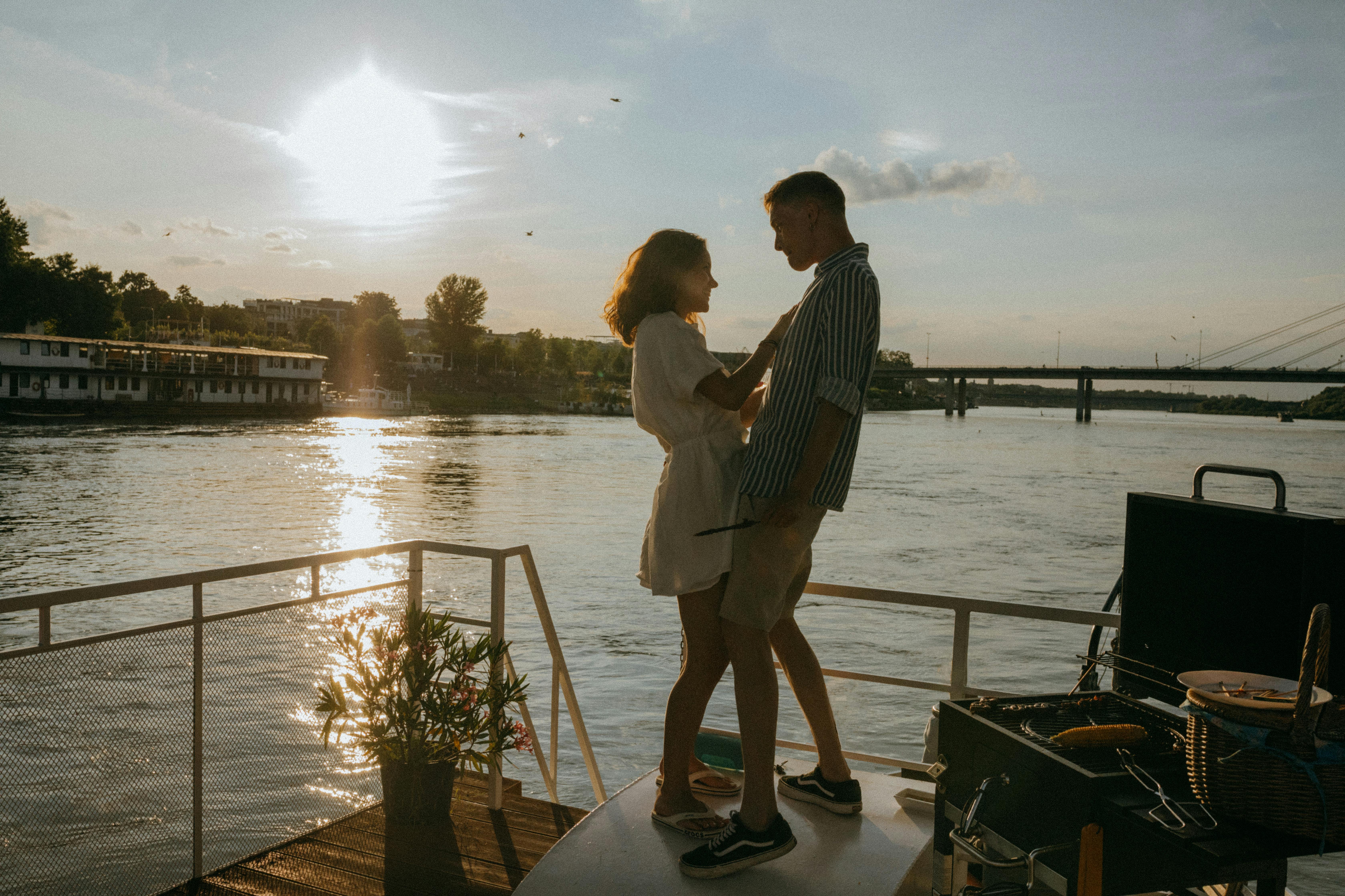 man and woman standing on dock