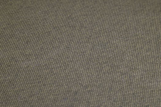 High-resolution close-up of olive green woven fabric, showcasing detailed texture and pattern.