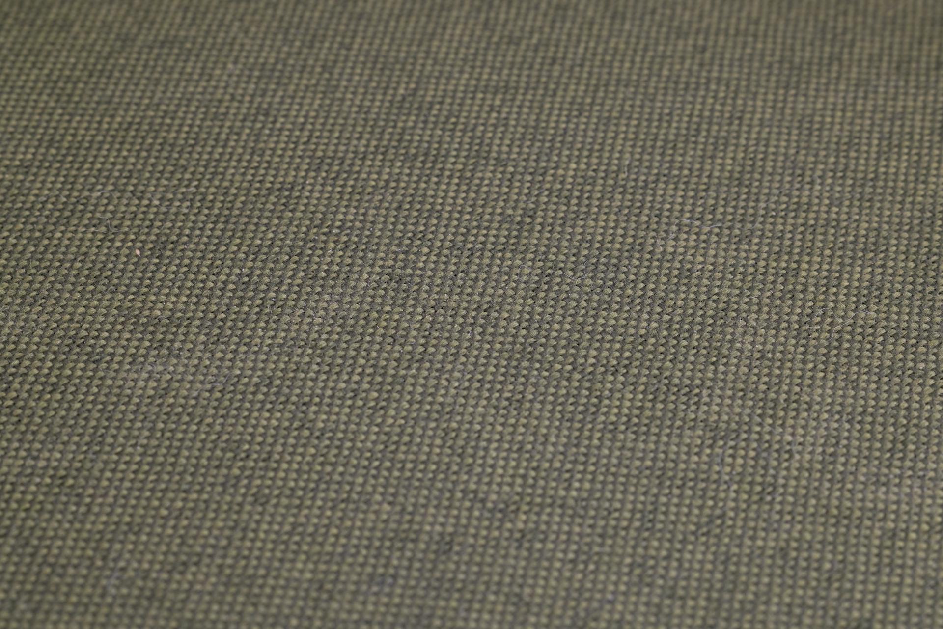High-resolution close-up of olive green woven fabric, showcasing detailed texture and pattern.
