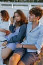 Woman in Blue Button Up Shirt Sitting Beside Woman in Gray Long Sleeve Shirt