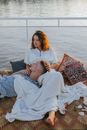 Woman in White Robe Lying on Bed With 2 Children