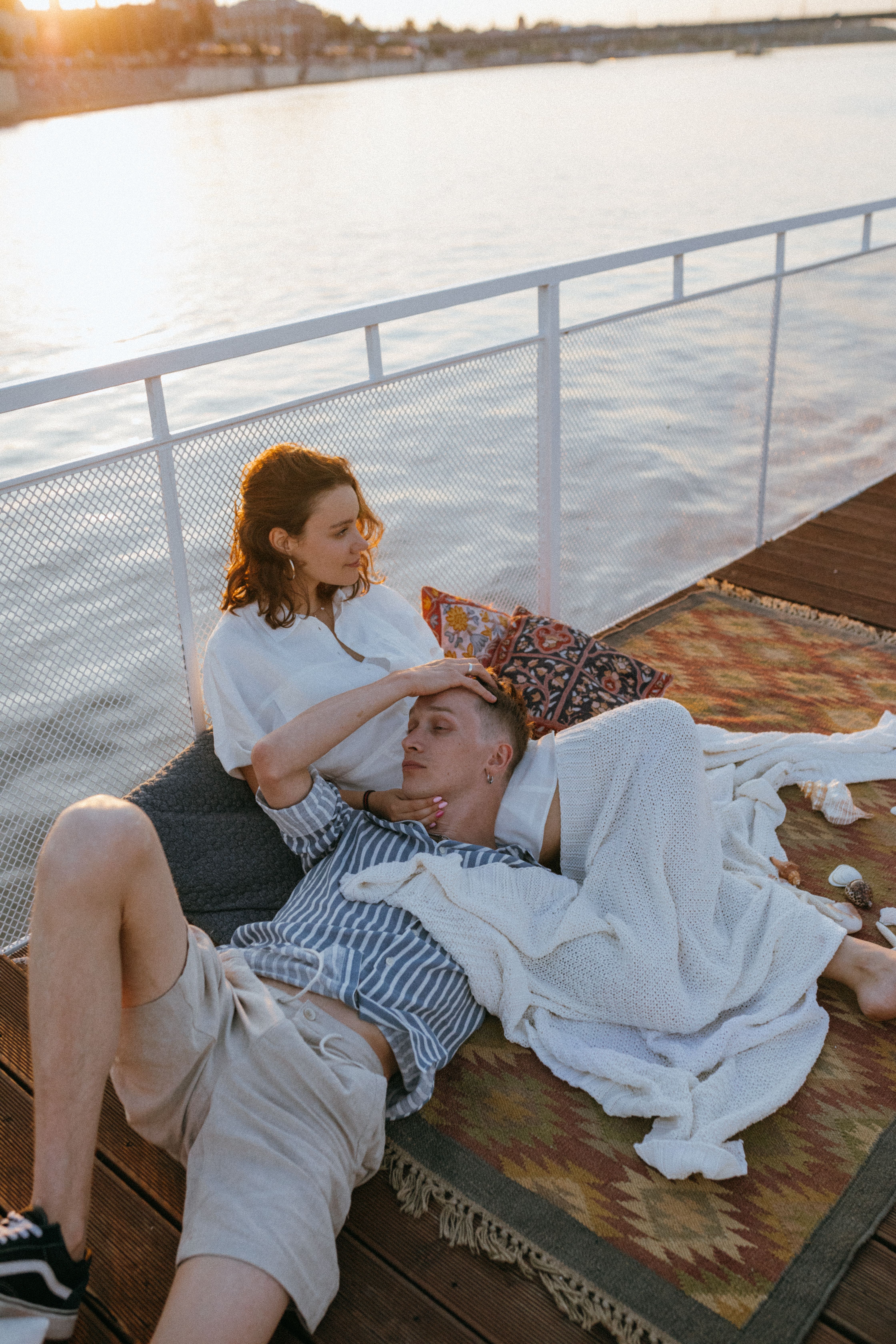 Couple on a private sailing catamaran at sunset off Nusa Dua, Bali
