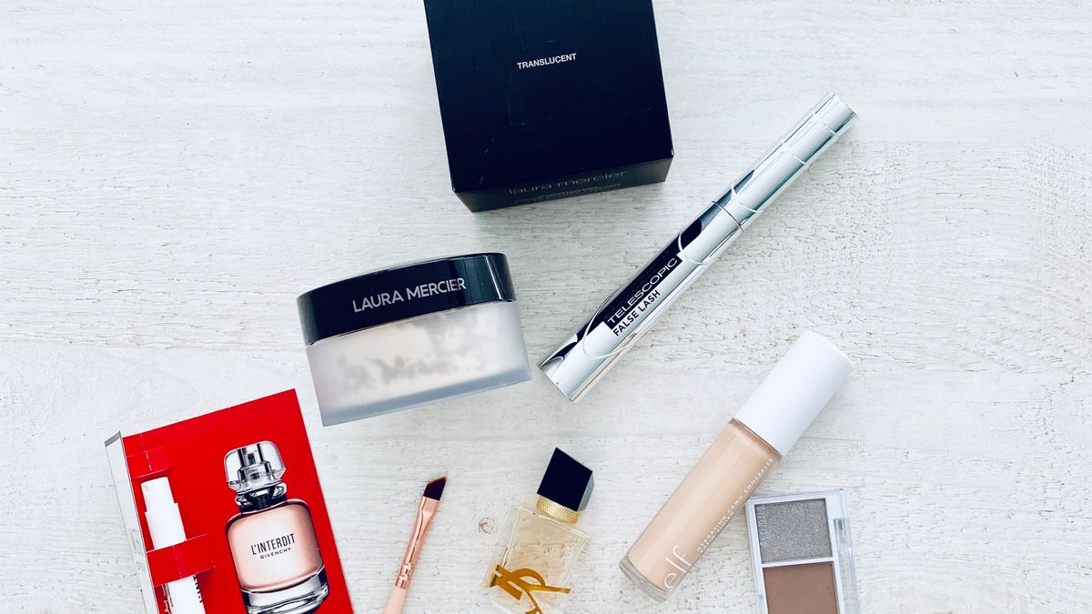 A collection of luxury makeup products arranged on a white background