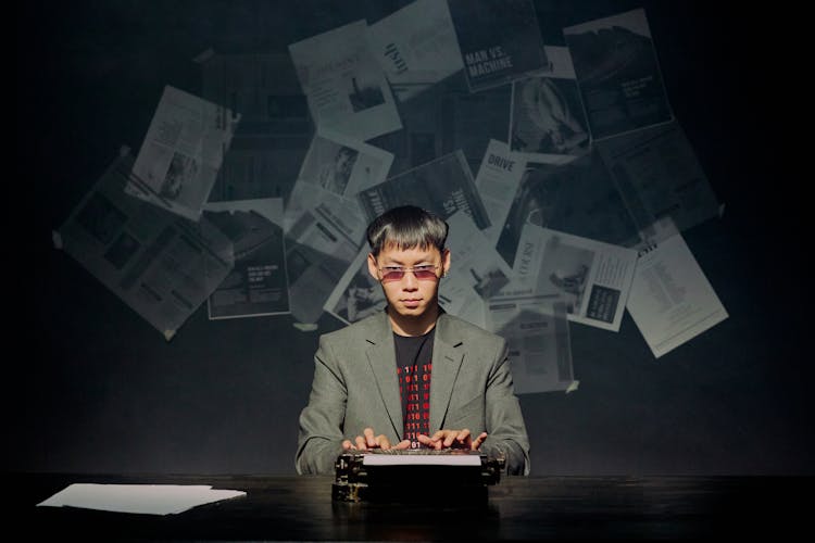 Man Writing On Typewriter And Looking At Camera