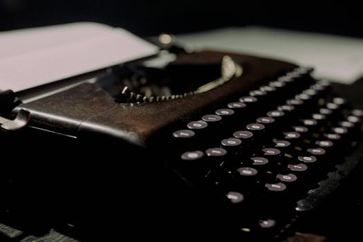 Close-up of a vintage typewriter with paper, capturing the essence of old-school writing.