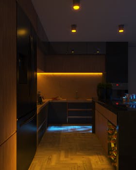 Modern kitchen interior featuring sleek cabinets and ambient LED lighting for a warm atmosphere.