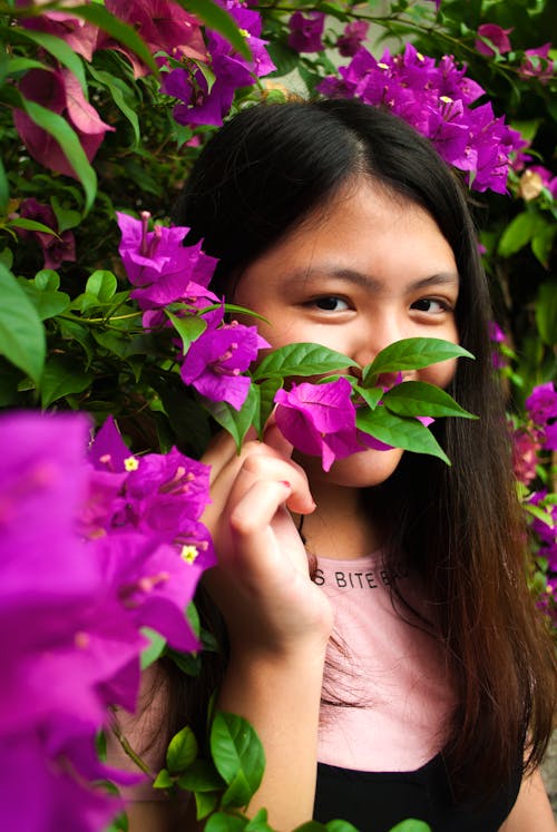 Woman Wearing Pink and Black Shirt Near Purple Petaled Flowers at Daytime