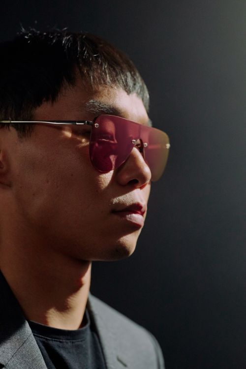 Free Stylish portrait of a man in sunglasses against a dark background. Stock Photo