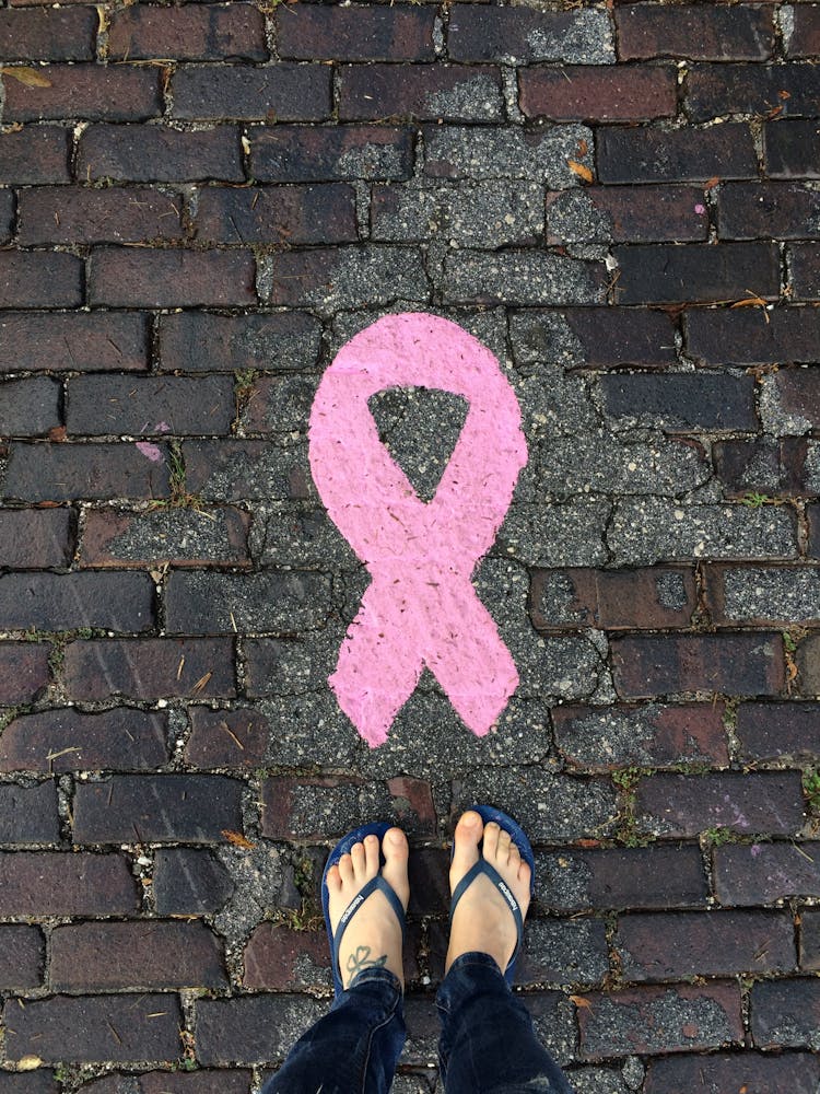 Woman Standing Next To A Pink Sign 