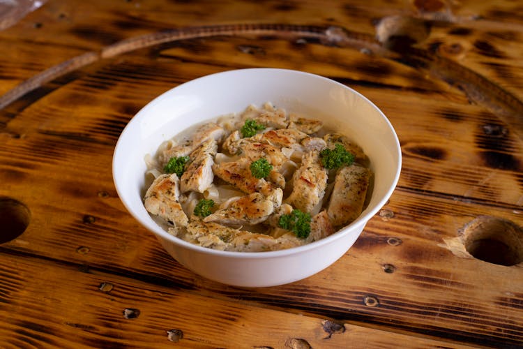 Chicken Pasta With Broccoli In A White Bowl