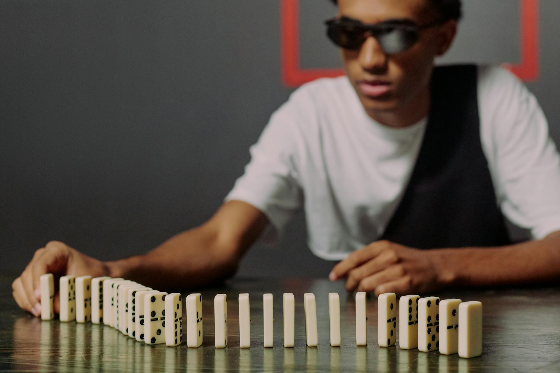 Man sitting and taking one of the domino blocks