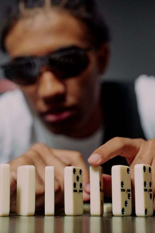 Man taking one of the domino blocks · Free Stock Photo