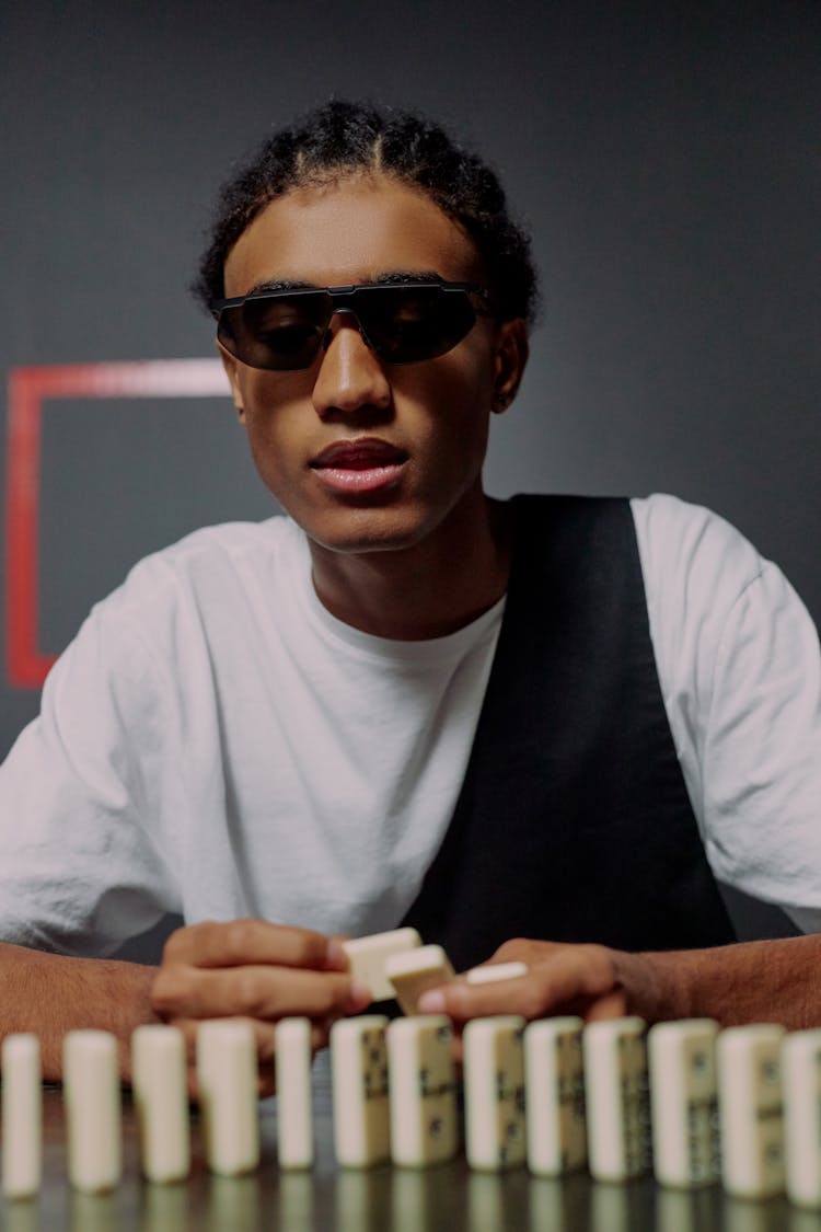 Man Sitting And Having Domino Blocks In Hands