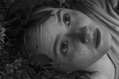 Free Grayscale Photography of a Woman Lying on Grass Stock Photo