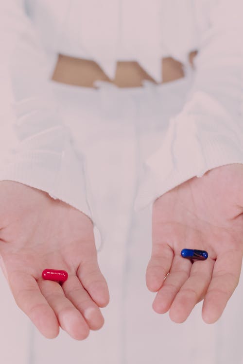 Woman holding and showing pills 