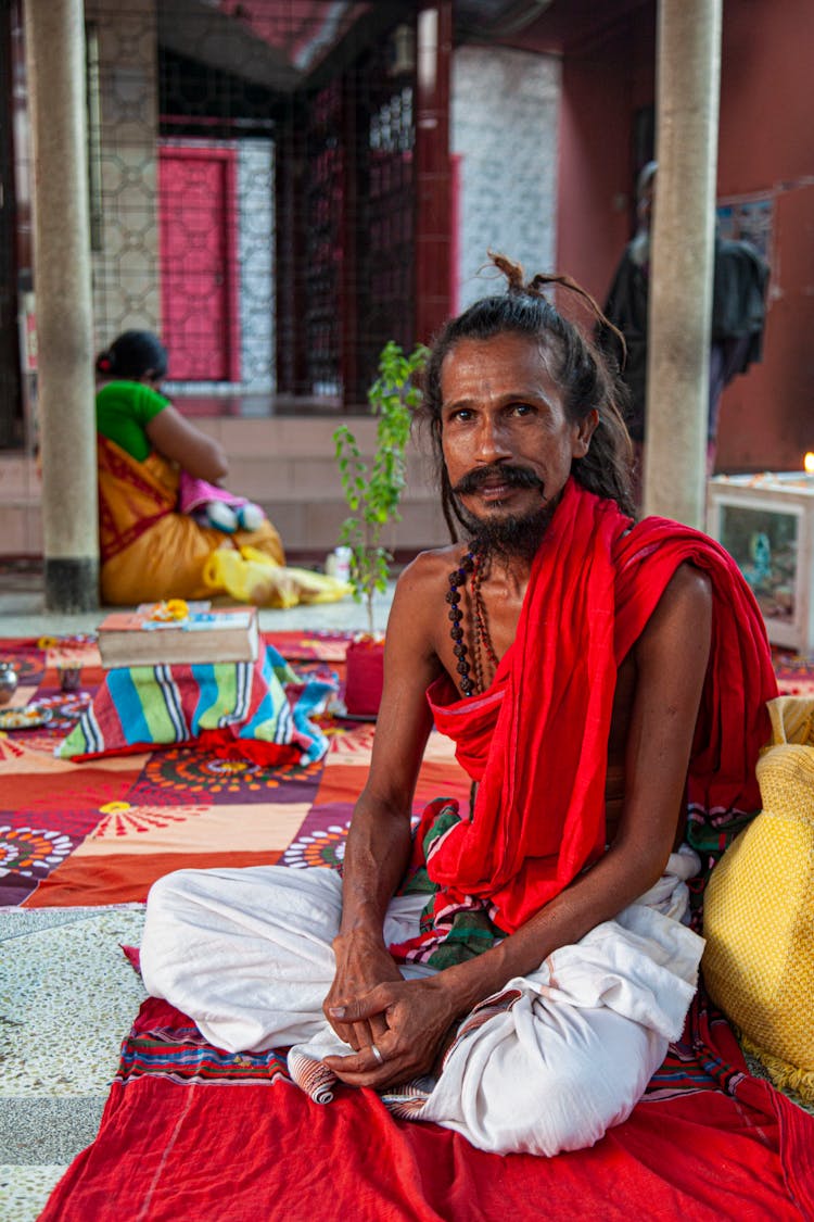 Man Sitting On Carpets