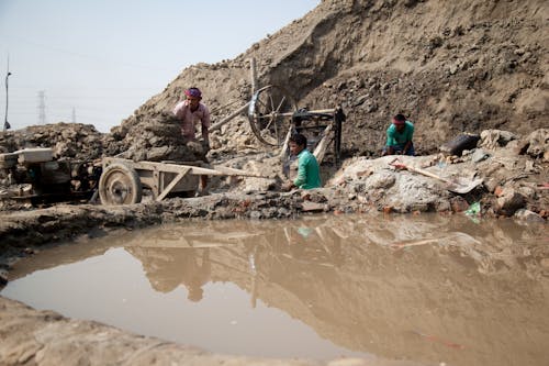 Men Standing in the Mud after a Flood in Bangladesh