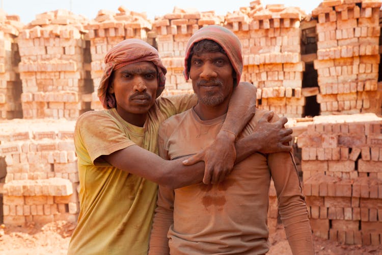 Men Working On Brick Field Outdoors