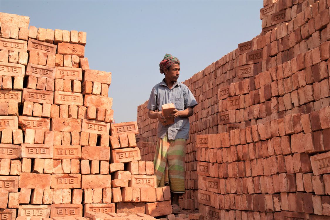Stacking Builders A Man Stacking Bricks · Free Stock Photo