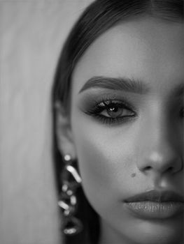 Captivating black and white portrait of a woman in close-up with elegant earring.