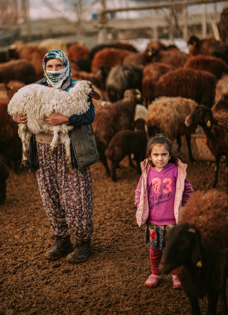 Mother And Daughter With Sheep