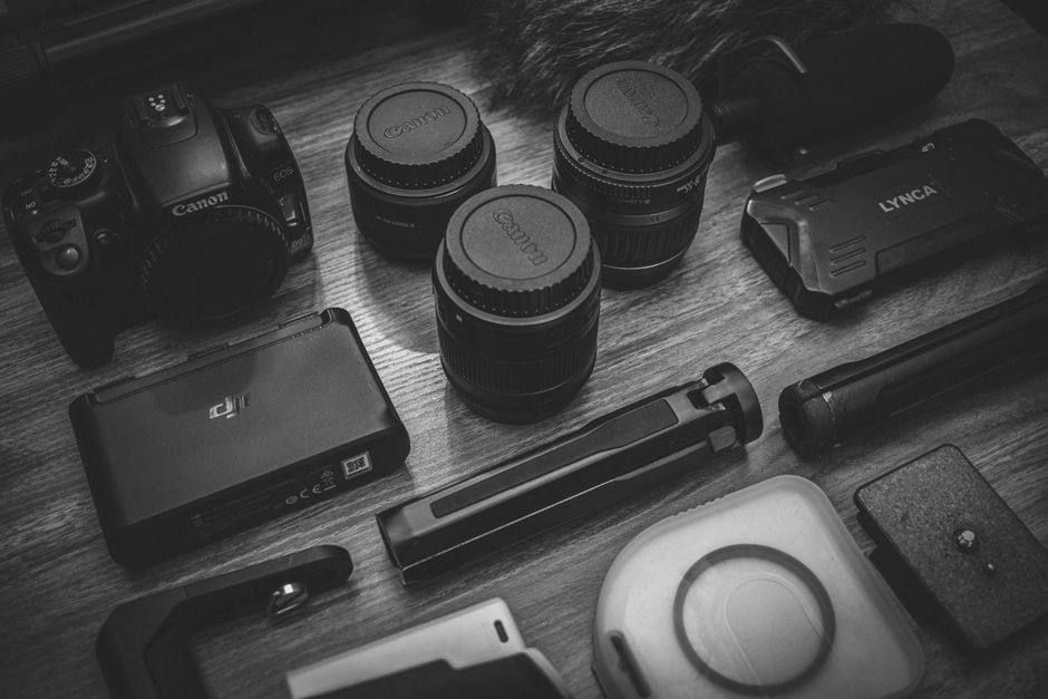 Kit fotográfico Canon: câmera, três lentes, flash Lynca, bateria, grip e acessórios diversos