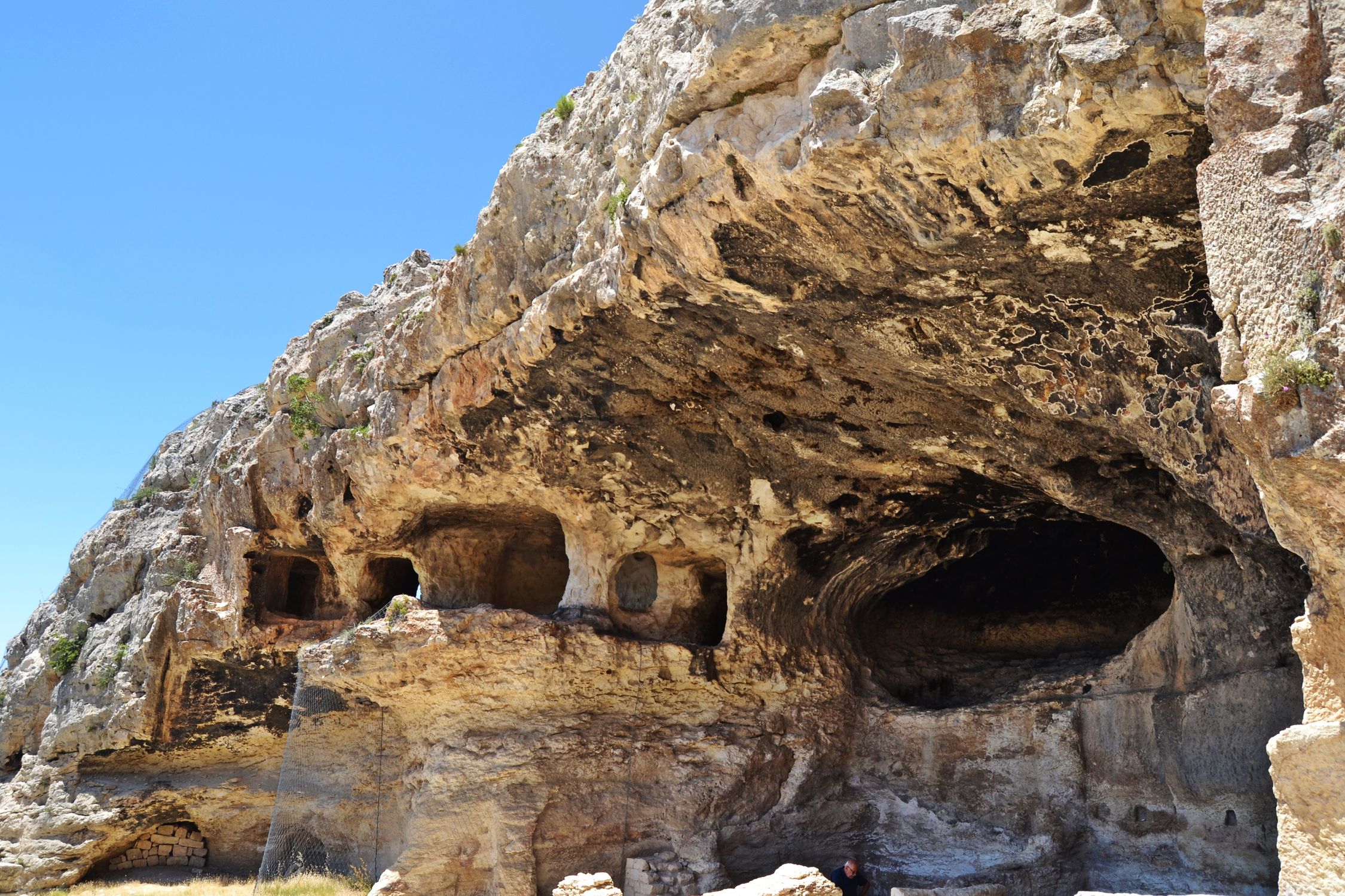 Caves in Sandstone Cliff · Free Stock Photo