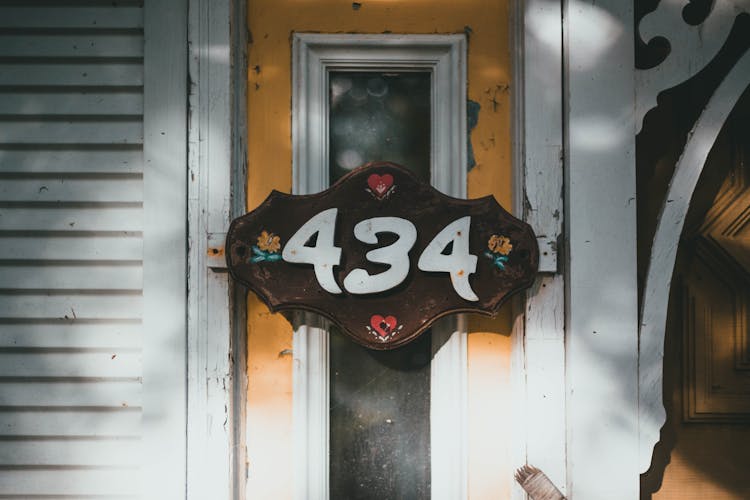 Close-up Of A Wooden House Number Sign