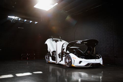 Free A White Sports Car Parked inside the Garage Stock Photo