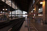 View of the interior of Gare du Nord railway station in Paris, showcasing tracks and architecture.