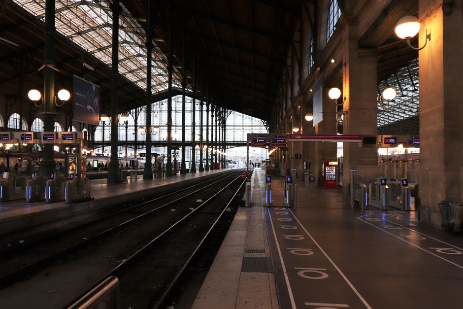 Inside a modern Paris metro station with commuters