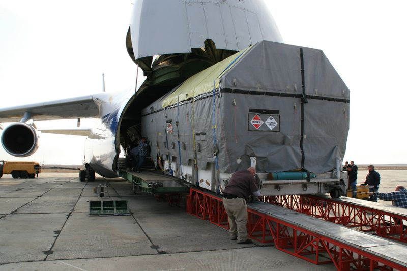 An Antonov heavy-lift cargo aircraft being loaded on an airport apron