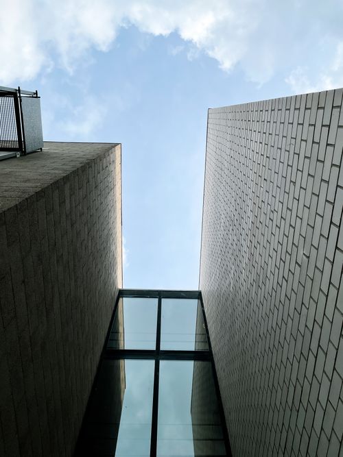 Free Low-angle view of modern buildings under a cloudy sky. Stock Photo