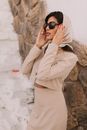 Portrait of elegant woman wearing pink shingle, scarf and sunglasses